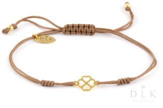 Bracelet “Beige string with a golden clover in hearts”