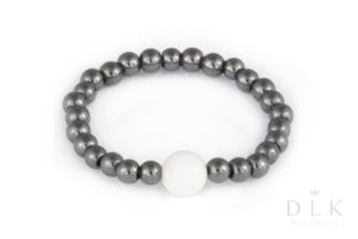 Flexible dark hematite ring with a white jade ball
