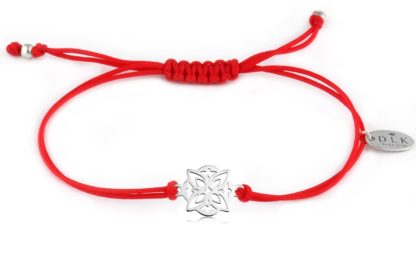 Bracelet with decorative silver rosette on a red string